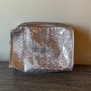 Large silver and clear makeup cosmetic case.